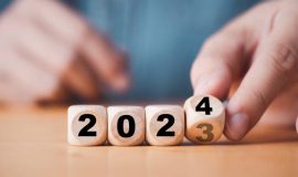 Hand flipping of 2023 to 2024 on wooden block cube for preparation new year change and start new business target strategy concept.